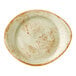 A green, oval-shaped ceramic plate with a speckled pattern and rustic brown edges.