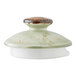 A ceramic lid for a 15 oz. green club teapot with a speckled glaze and a rounded handle.