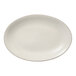 A white oval porcelain platter with a brown speckled border.