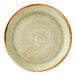 A round, green coupe plate with a speckled pattern and a brown rim.
