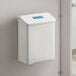 A white plastic wall-mount sanitary napkin receptacle.