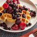 A plate of waffles topped with Simplot Simple Goodness Triple Berry Blend.