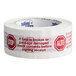 A roll of Tape Logic carton sealer tape with red and white text that reads "Stop / Alto"