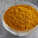 A bowl of Hometown Provisions Curry Powder on a gray surface.