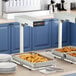 A Hatco Ultra-Glo portable food warmer with two trays of food on a counter.