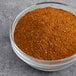 A bowl of ground spices on a table.