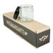 A Comandante clear glass bean jar with a black lid on a box.