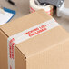 A box with Tape Logic "Packing List Enclosed" tape on it.