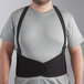 A man wearing a Lavex black adjustable back support belt over a grey shirt.