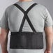 The back of a man wearing a black Lavex back support belt.
