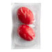 A vacuum-sealed package containing two red beet pickled hard cooked eggs.