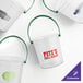 A group of clear Howw Manufacturing plastic buckets with green handles.