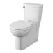 An American Standard white floor mount toilet with a seat down.