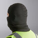 A person wearing a Lavex black fleece balaclava face mask.