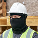 A man wearing a black Lavex fleece balaclava face mask under a helmet.