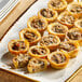 A plate of Simply Cuisine Wild Mushroom Tarts on a table.