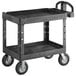 A black Rubbermaid utility cart with two shelves and wheels.