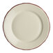 A close-up of a Homer Laughlin white china plate with red scalloped trim.