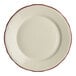 A close-up of a Homer Laughlin white china plate with maroon scalloped trim.
