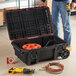 A man standing next to a yellow and black Tough Box rolling tool chest.