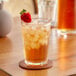 A glass of Twinings iced tea with a strawberry on top.