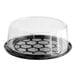 A D&W Fine Pack black plastic cake display container with a clear scalloped dome lid.