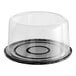 A clear plastic cake display container with a clear scalloped lid.