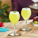 Two glasses of yellow Primor Lulo puree on a table.