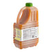 A plastic jug of Primor Peach Puree with a green cap.