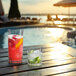 Two Spiegelau Perfect Serve Pool rocks glasses with cocktails and ice and limes on a table.