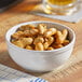 A bowl of Peanut Patch Cajun boiled peanuts on a table.