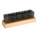 A wooden brush with metal bristles.