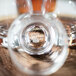 A close up of a Reserve by Libbey Kentucky Bourbon Trail cocktail glass filled with whiskey.