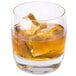 A Reserve by Libbey Symmetry rocks glass filled with amber liquid and ice.