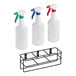 A metal rack holding three Lavex assorted color spray bottles.