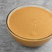 A bowl of Vor peanut butter on a table.