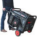 A man holding a Tomahawk gasoline-powered portable welder generator.