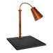 A Hanson Heat Lamps copper carving station on a black square surface.