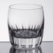 A close up of a clear Libbey Reserve Chisel Rocks glass with a curved edge.