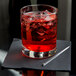 A Libbey Lexington rocks glass with red liquid and ice.