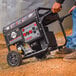 A man pushing a Tomahawk portable generator.