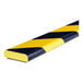 A close up of a yellow and black striped Ideal Warehouse Knuffi Magnetic Surface Guard.