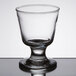 A Libbey footed rocks glass with a small rim on top.