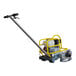 A Tomahawk walk-behind concrete saw with a yellow handle.
