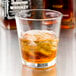 A Libbey stackable rocks glass with ice and amber liquid.