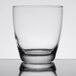 A close up of a Libbey Embassy clear rocks glass on a reflective surface.