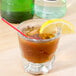 A Libbey rocks glass of iced tea with a lemon slice and a straw.