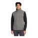 A man wearing a medium gray The North Face fleece sweater vest.
