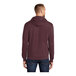 A man wearing a Port & Company heather athletic maroon core fleece pullover hoodie with a hood.