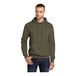 A man wearing an olive drab green Port & Company core fleece pullover hoodie.